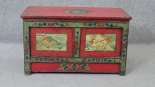 An Eastern painted cabinet with hand decorated panels depicting a tiger and a Foo dog. H.43 W.73 D.