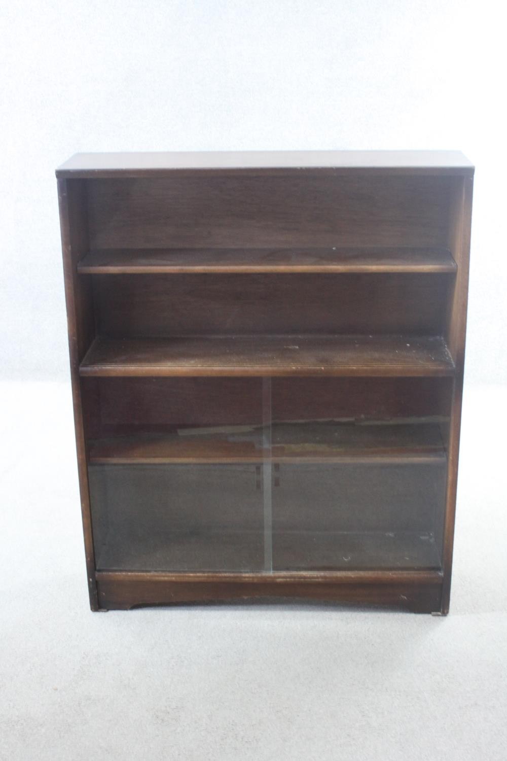 A vintage teak bookcase with open shelves above sliding plate glass doors. H.113 W.91 D.25 cm. - Image 2 of 5
