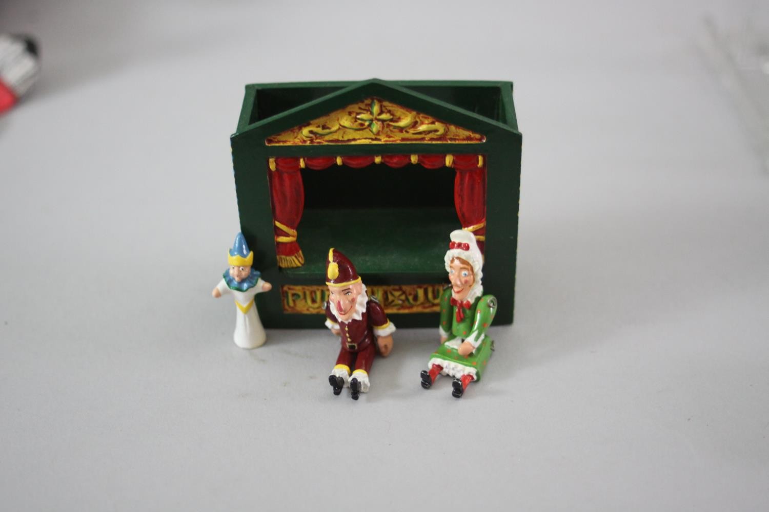 A miniature painted die cast Punch and Judy theatre with three articulated dolls along with two - Image 4 of 6