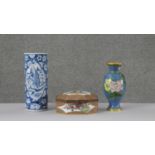 A gilt brass cloisonne enamel vase decorated with peonies on a blue cloud design background, a