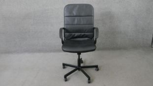 A contemporary office desk chair in faux leather upholstery.