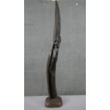 A large figural driftwood carving on a wooden base. H.109 W.19 D.17cm