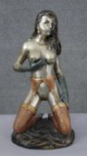 An Art Deco style patinated brass erotic figure of a nude kneeling woman in stockings and