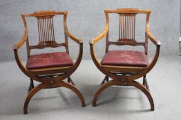 A pair of late 19th century rosewood armchairs with pierced splat backs above drop in seats on X