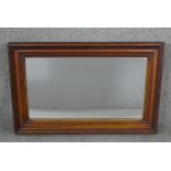 A C.1900 wall mirror in moulded and reeded mahogany frame. H.80 W.54cm