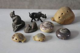 A collection of carved stone and ceramic items. Including three Art Pottery ocarinas, two bronzed