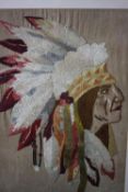 A framed and glazed silk embroidery of a Native American chief. H.70 W.57 cm.