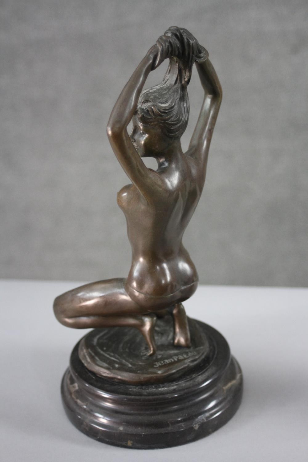 An erotic spelter figure of a kneeling nude woman holding up her hair. H.30 W.16 cm. - Image 2 of 3