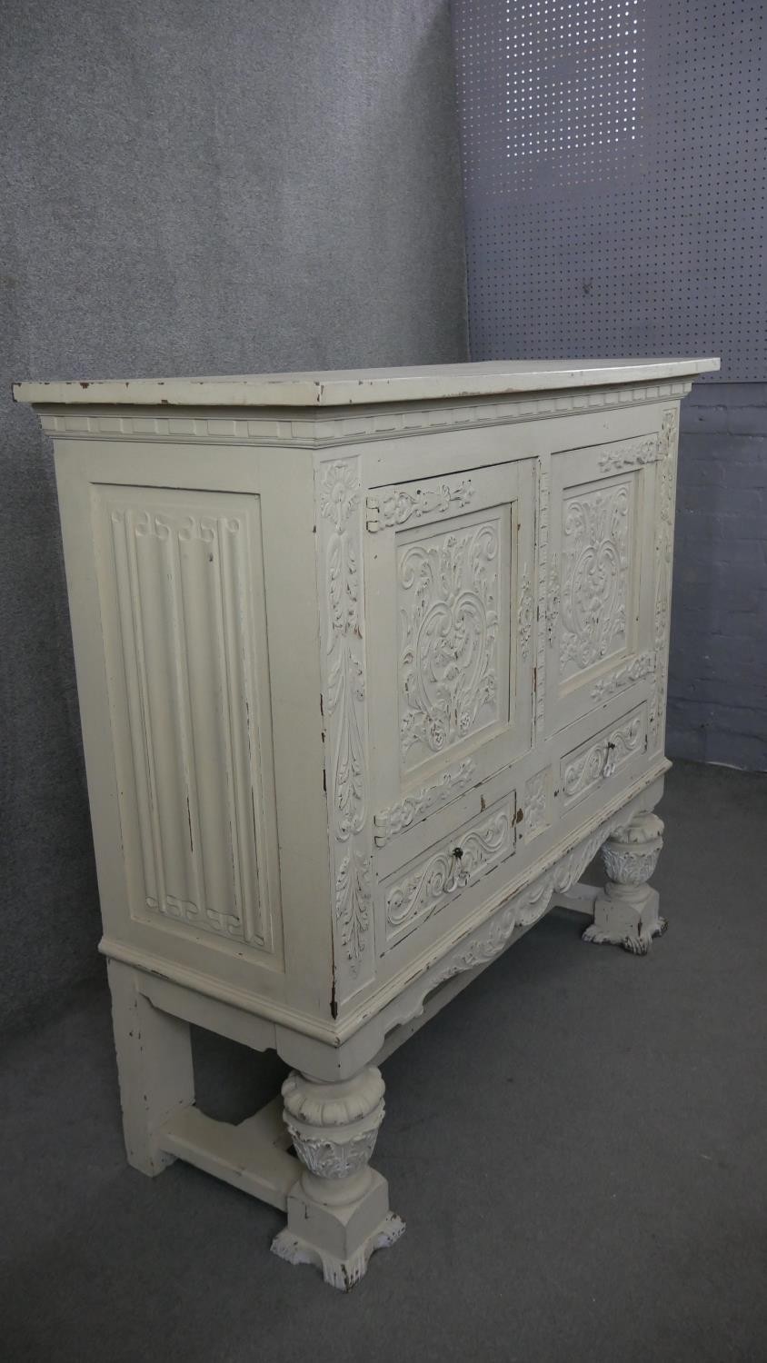 An early 20th century distressed painted 18th century style cabinet with all over carving on - Image 6 of 7