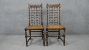 A pair of early 20th century walnut Carolean style hall chairs with pierced and carved back splats