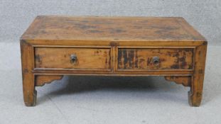 An Eastern hardwood low table fitted with drawers on shaped supports. H.25 W.65 D.40 cm