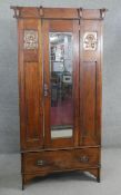 A late 19th century oak Arts and Crafts wardrobe with inset embossed copper panels. H.190 W.89 D.