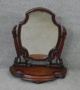 A mid 19th century mahogany swing toilet mirror on shaped platform base. H.80 W.73 D.28 cm