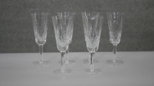 A set of six Waterford hand cut crystal champagne flutes with star cut bases. H.19 Diam.7cm