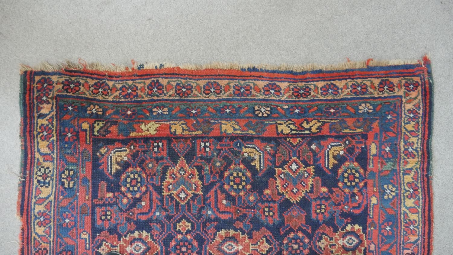 A Persian Mahal carpet with allover floral decoration on a midnight blue ground contained within - Image 4 of 5