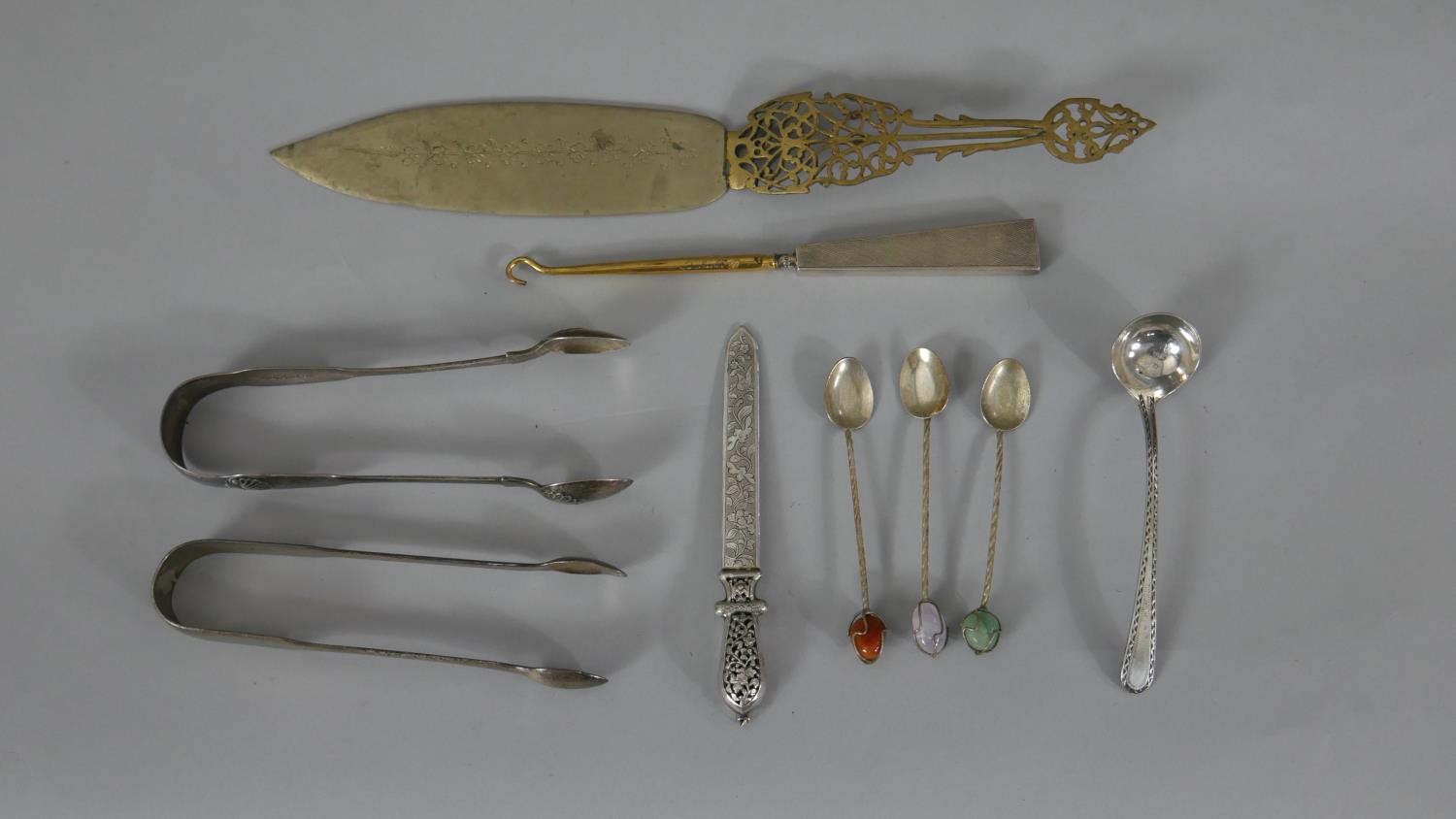 A collection of silver and silver plate. Including two sets of silver sugar tongs, one with shell