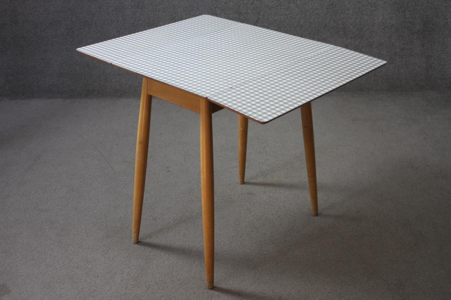 A mid century vintage drop flap kitchen table with gingham check laminated top. H.74 W.89 D.68 cm. - Image 6 of 11