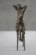 A patinated erotic spelter figure of a seated nude lady. H.27 W.10 cm.