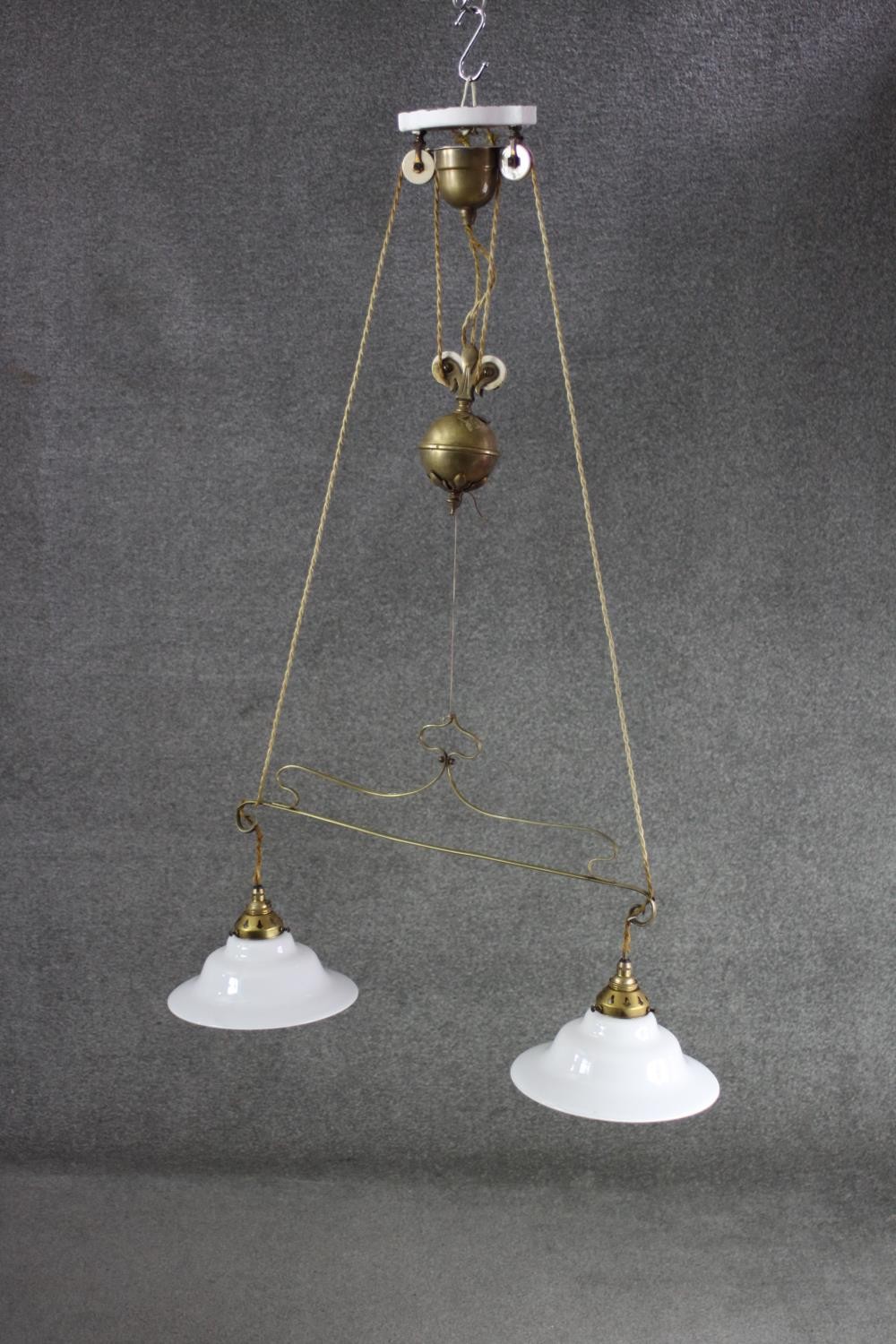 A French brass rise and fall ceiling light with original opaque white glass shades. H.100 w.70 CM - Image 2 of 6