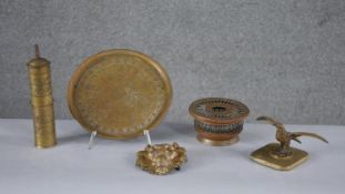 A collection of brass items. Including a lion head belt buckle, a Dutch Art Nouveau Daalderop