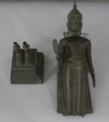 A 19th century bronze figure of a walking Buddha on square plinth. H54 W.11 D.11cm (total)