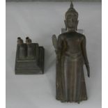 A 19th century bronze figure of a walking Buddha on square plinth. H54 W.11 D.11cm (total)