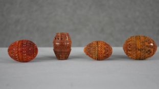 Four 19th century coquilla nut pierced design sewing eggs and thimble holders. Each with a repeating