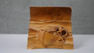 A carved pine relief figure of a man in a rowing boat at sea. Indistinctly signed to the back. H.