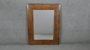 A contemporary Eastern hardwood wall mirror. H.121 W.89cm