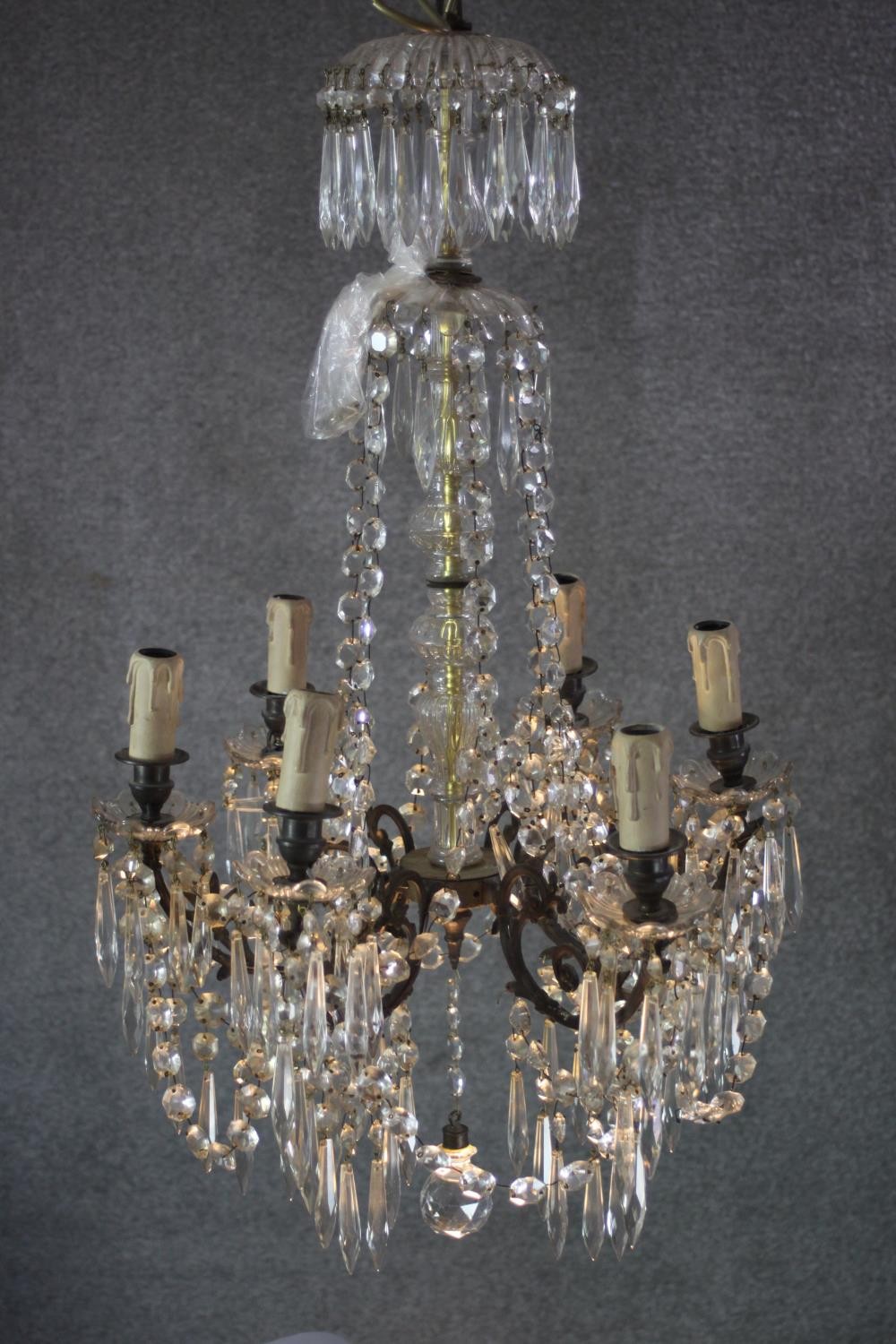 A vintage cut crystal and brass six branch chandelier with crystal swags and faceted ball to the
