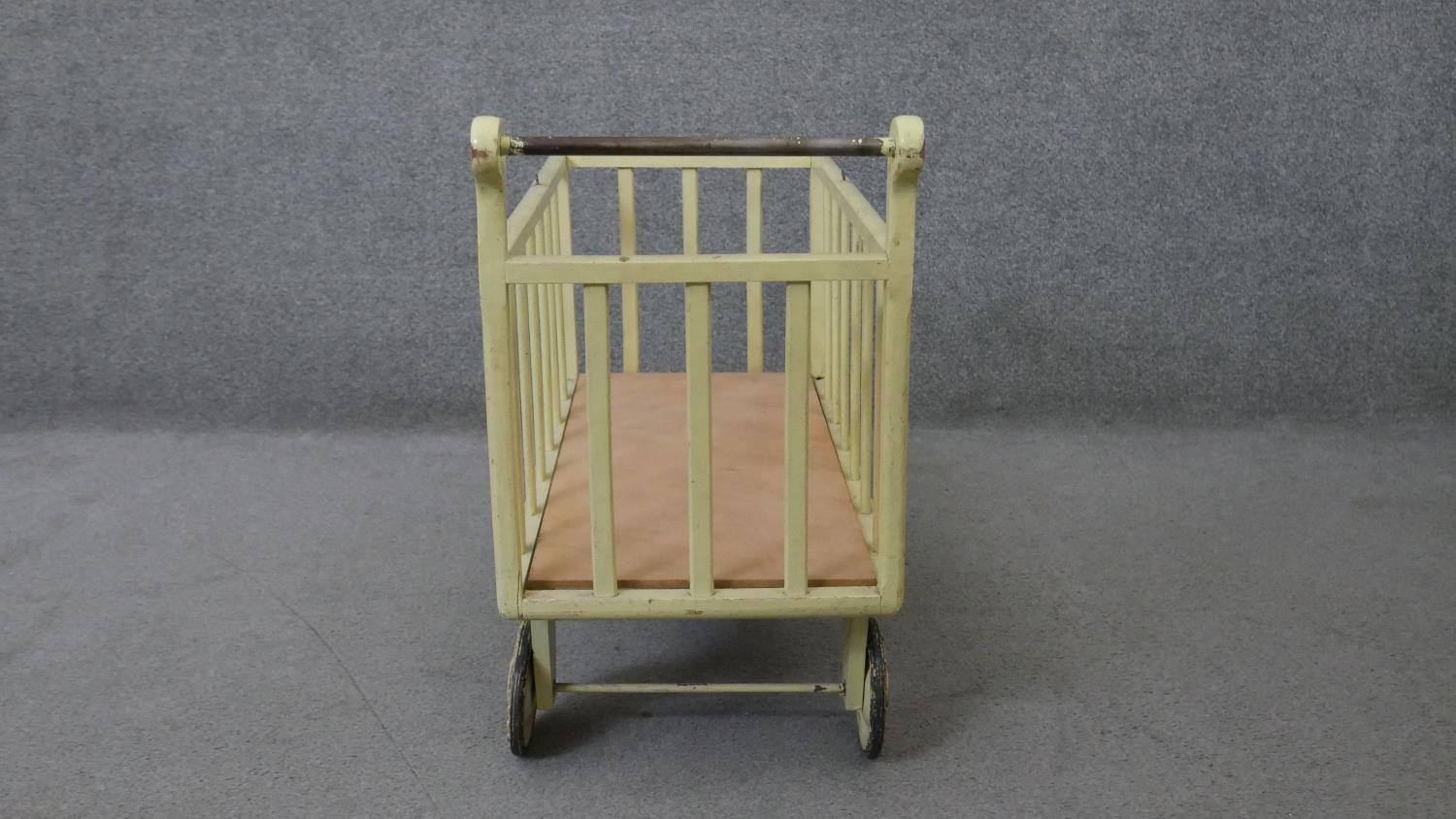 A vintage painted child's toy trolley or doll's pram. H.58 W.75 D.34 cm - Image 3 of 4