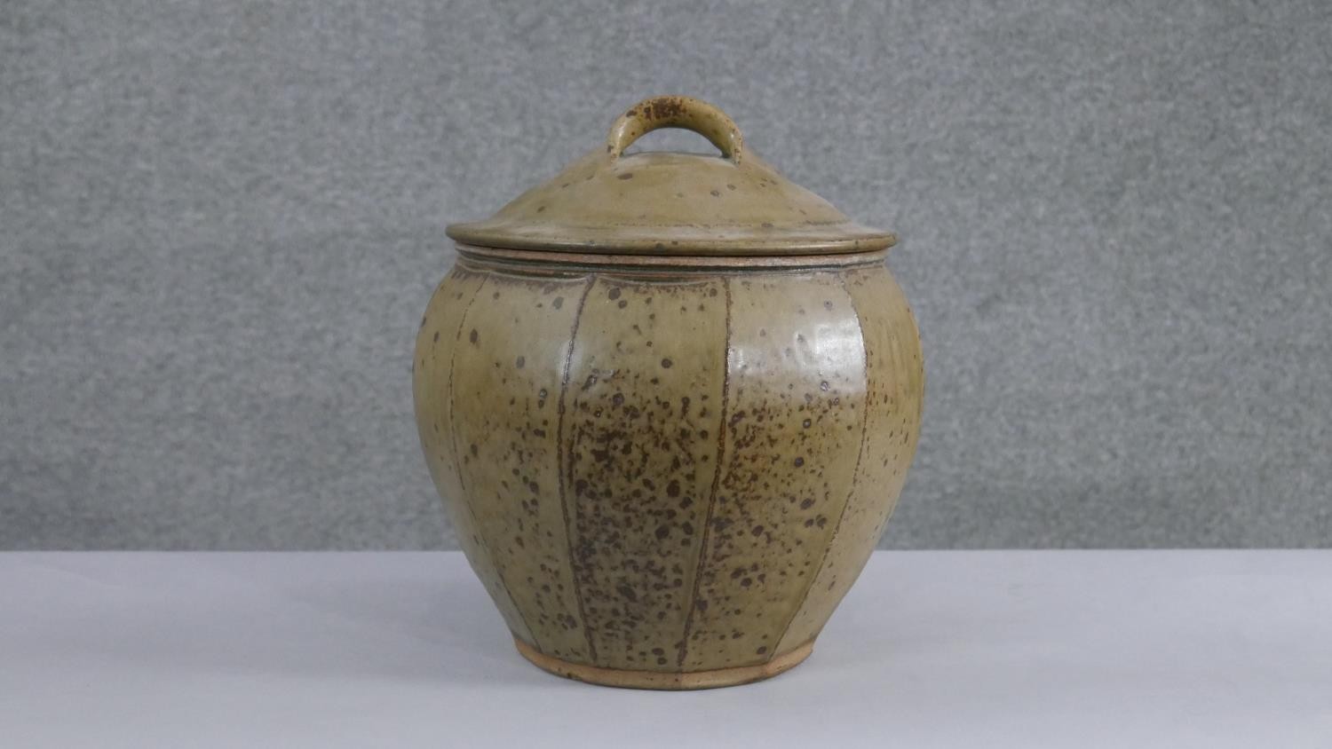 Phil Rogers (1951-2020) - a large art pottery jar and handled cover with green ash glaze, the body