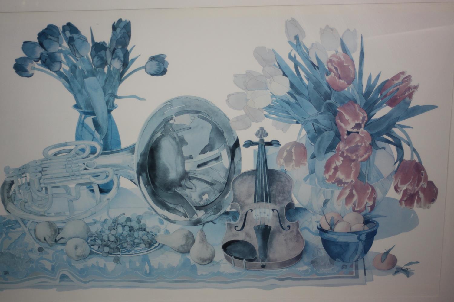 A large framed and glazed print of a still life with violin, tuba and flowers. H.90 W.130 cm