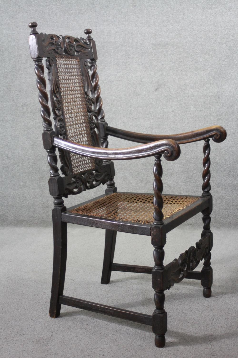 A late 19th century carved oak armchair with caned back and seat on stretchered barleytwist - Image 4 of 7