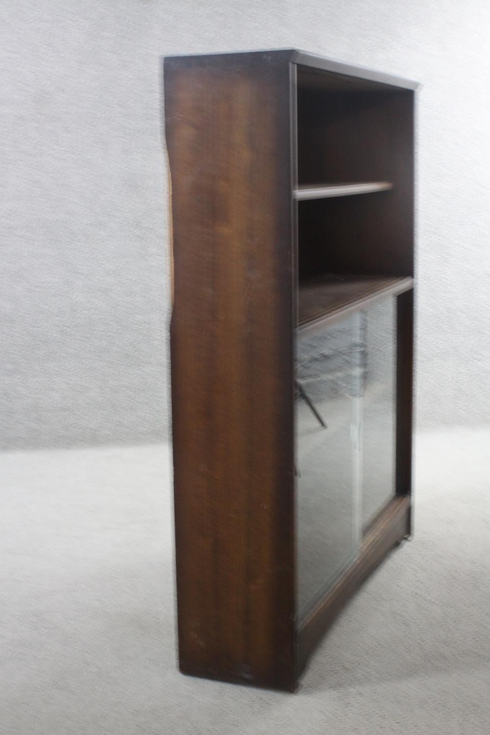 A vintage teak bookcase with open shelves above sliding plate glass doors. H.113 W.91 D.25 cm. - Image 3 of 5