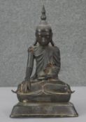 A 19th century bronze Thai seated Buddha figure on lotus flower base, engraved script to the base.