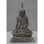 A 19th century bronze Thai seated Buddha figure on lotus flower base, engraved script to the base.