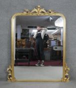 A 19th century style gilt framed overmantel mirror with moulded floral cresting and detail. H.152