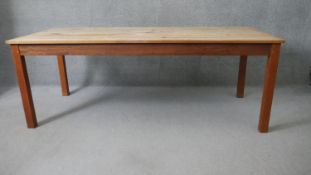 A Retrouvius refectory dining table with reclaimed poplar planked top raised on square tapering