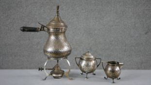 A late 19th century Arts and Crafts three piece Continental hammered silver plate coffee set.