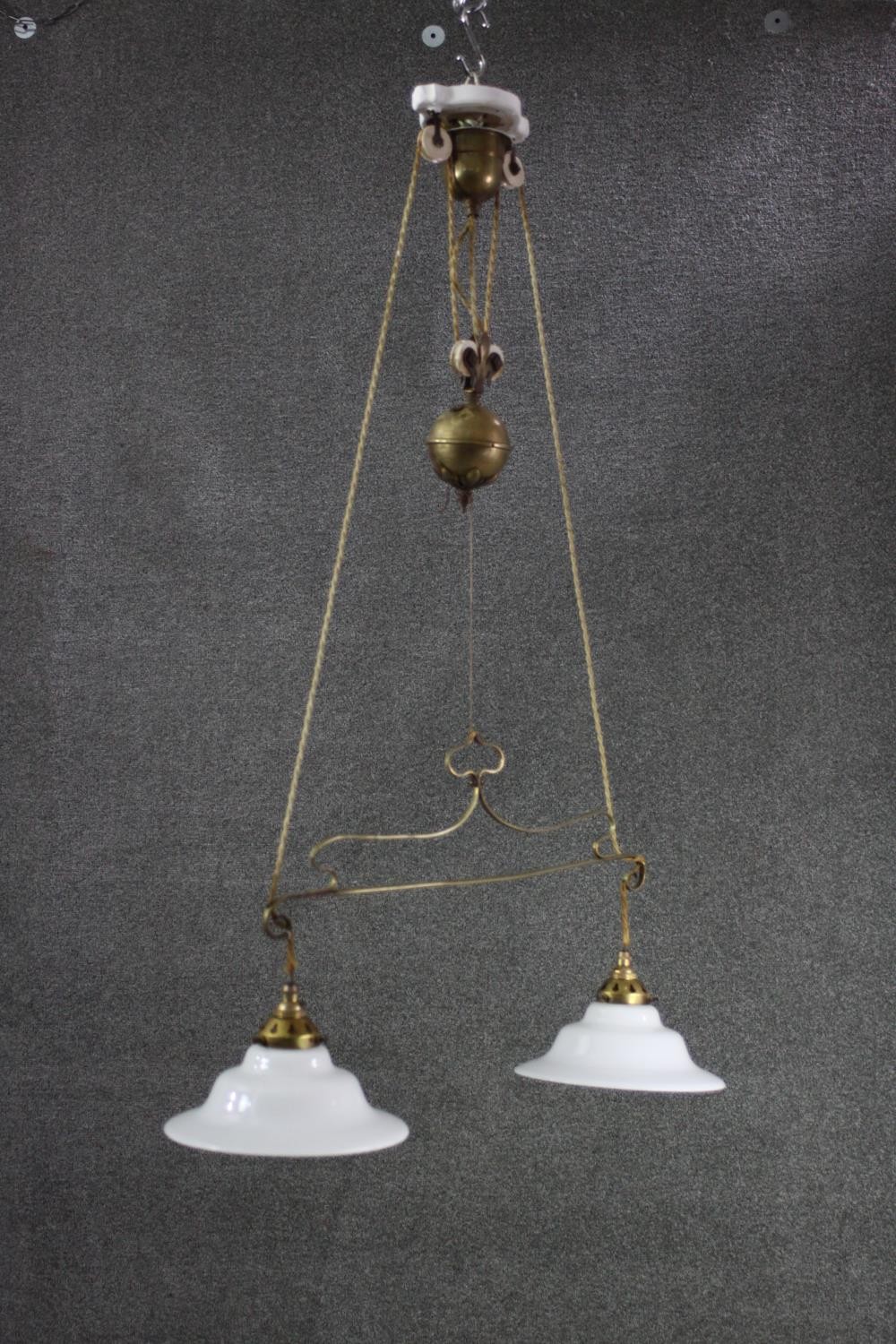 A French brass rise and fall ceiling light with original opaque white glass shades. H.100 w.70 CM - Image 3 of 6