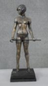 After Bruno Zach, a patinated brass erotic figure of a dominatrix with cane. Mounted on a black onyx