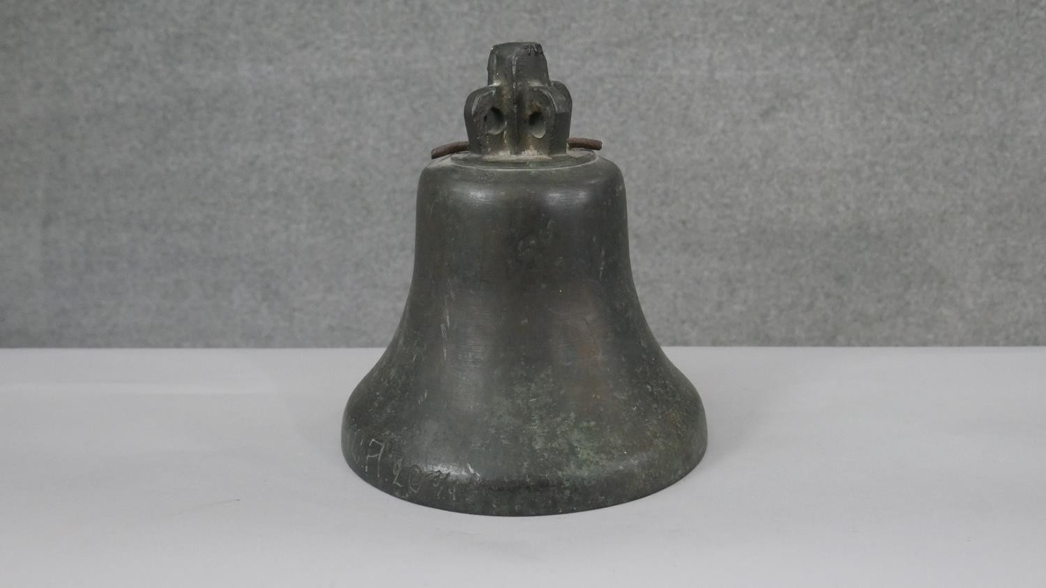 An early 20th century bronze bell, inscribed to the rim 20 3/4. H.25 Diam.24cm