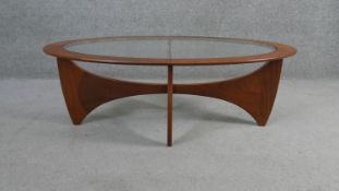 A mid century vintage teak G-Plan Astro coffee table with inset plate glass top on shaped X