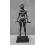 After Bruno Zach, a patinated spelter erotic figure of a dominatrix with cane. Mounted on a black