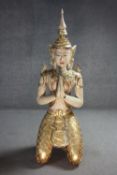 A large early 20th century Thai carved and gilded kneeling Buddha statue. Adorned with mirrored