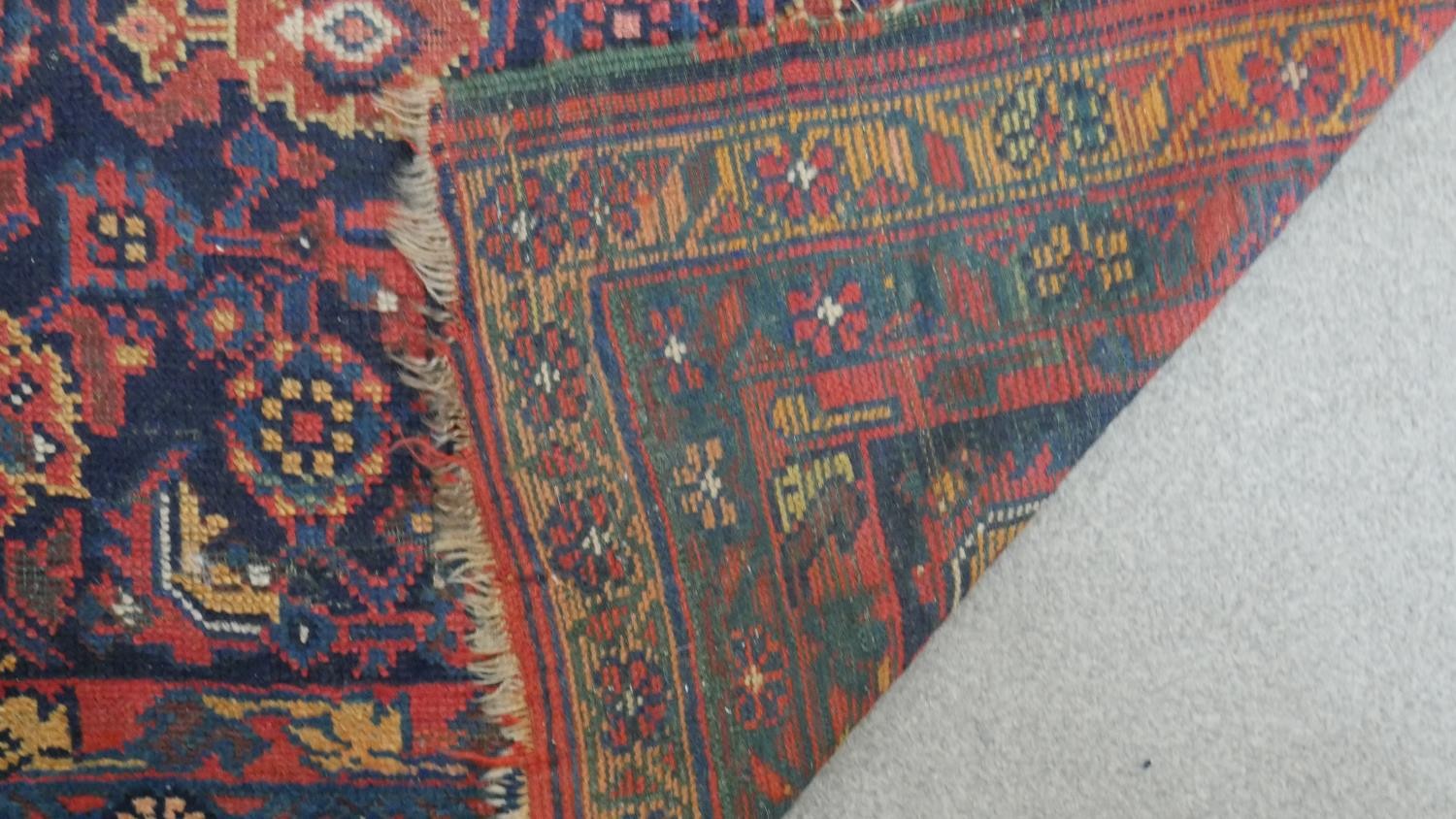 A Persian Mahal carpet with allover floral decoration on a midnight blue ground contained within - Image 5 of 5