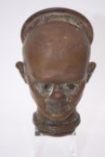An early 20th century bronze doll head mould. H.14 W.10 D.9 cm