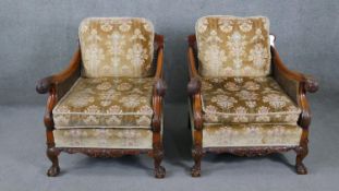 A pair of mid century carved walnut bergere armchairs with double caned sides in cut floral