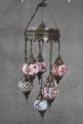 A Turkish pierced brass mosaic glass seven drop lantern chandelier with spare bulbs. H.100 Diam.